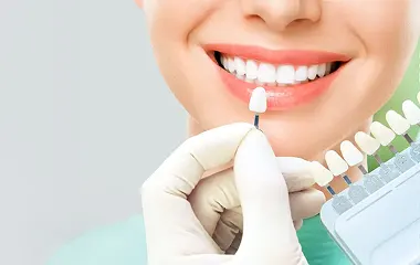 Custom-fit dentures shown with a smiling patient enjoying a beach town in Mexico, optimized for mobile view.